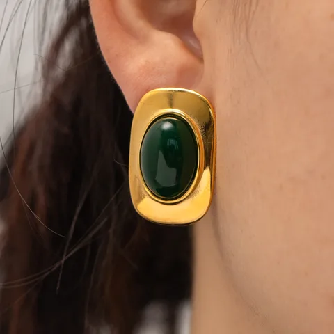 Close-up of emerald green stone set in antique 18K gold plating on lightweight hypoallergenic earrings